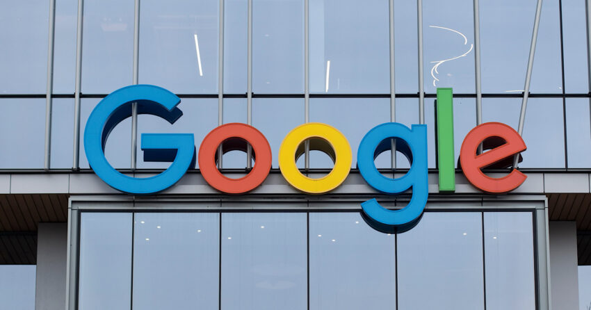 The Google logo in colorful letters on the facade of a modern building with large glass windows, highlighting the new Auto Ads format.